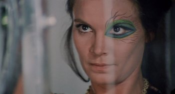 Movie still from “Investigation of a Citizen Above Suspicion” (1970), directed by Elio Petri – A person with a face painting; Close Up shot, Over the shoulder angle