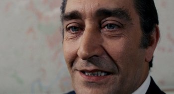 Movie still from “Investigation of a Citizen Above Suspicion” (1970), directed by Elio Petri – A man's eyes and face; Close Up shot, Over the shoulder angle