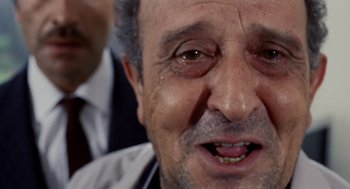 Movie still from “Investigation of a Citizen Above Suspicion” (1970), directed by Elio Petri – An old man with a beard and a mustache; Extreme Close Up shot, Low angle
