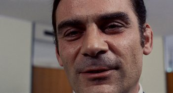 Movie still from “Investigation of a Citizen Above Suspicion” (1970), directed by Elio Petri – A man's face with a lot of dirt on it; Close Up shot, Low angle