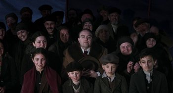 Movie still from “Invincible” (2001), directed by Werner Herzog – A large group of people wearing hats and coats; Medium shot, High angle