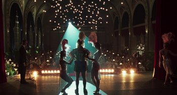 Movie still from “Invincible” (2001), directed by Werner Herzog – A group of women performing on a stage with lights in the background; Extreme Wide shot, Low angle