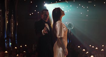 Movie still from “Invincible” (2001), directed by Werner Herzog – A man and a woman singing in front of an audience; Medium shot, Low angle