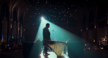 Movie still from “Invincible” (2001), directed by Werner Herzog – A man and a woman standing in the light of a stage; Wide shot, Low angle