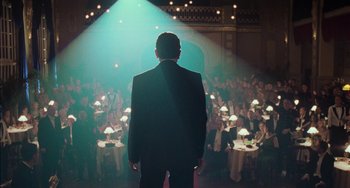 Movie still from “Invincible” (2001), directed by Werner Herzog – A man standing in front of a crowd of people; Wide shot, Low angle