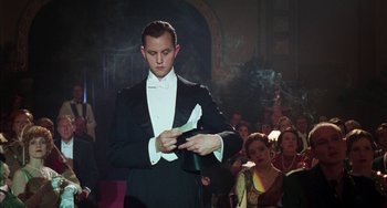 Movie still from “Invincible” (2001), directed by Werner Herzog – A man in a black suit and a white hat; Medium shot, Low angle