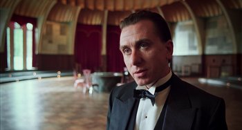 Movie still from “Invincible” (2001), directed by Werner Herzog – A man in a tuxedo standing next to a table; Close Up shot, Low angle