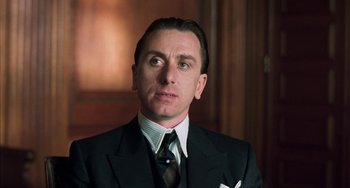 Movie still from “Invincible” (2001), directed by Werner Herzog – A person wearing a suit and tie; Close Up shot, Low angle