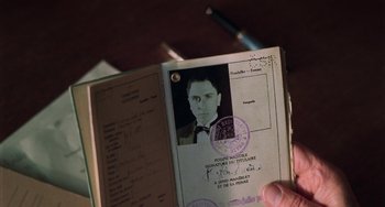 Movie still from “Invincible” (2001), directed by Werner Herzog – A person is holding a passport with a picture of a man; Extreme Close Up shot, High angle