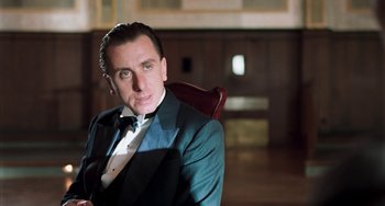 Movie still from “Invincible” (2001), directed by Werner Herzog – A person sitting in a chair wearing a suit; Close Up shot, Low angle