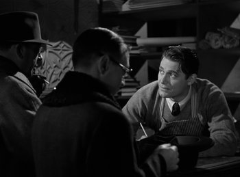 Movie still from “Invisible Agent” (1942), directed by Edwin L. Marin – Two men sitting at a table talking to each other; Medium shot, Over the shoulder angle
