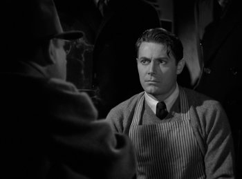 Movie still from “Invisible Agent” (1942), directed by Edwin L. Marin – A man wearing a striped shirt and a striped tie; Close Up shot, Over the shoulder angle