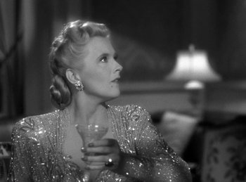 Movie still from “Invisible Agent” (1942), directed by Edwin L. Marin – An older woman holding a glass in her hand; Close Up shot, Over the shoulder angle