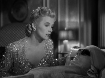 Movie still from “Invisible Agent” (1942), directed by Edwin L. Marin – An old photo of a woman looking at a man; Close Up shot, Over the shoulder angle