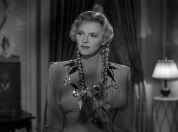 Movie still from “Invisible Agent” (1942), directed by Edwin L. Marin – A black and white photo of a woman with long braids; Close Up shot, Low angle