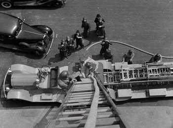 Movie still from “Invisible Agent” (1942), directed by Edwin L. Marin – An aerial view of a group of people on a street; Wide shot, Overhead angle