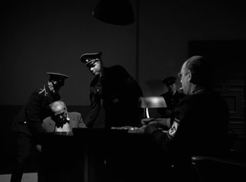 Movie still from “Invisible Agent” (1942), directed by Edwin L. Marin – A group of men sitting around a table; Wide shot, Over the shoulder angle