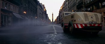 Movie still from “Irma la Douce” (1963), directed by Billy Wilder – A car driving down a street near tall buildings; Extreme Wide shot, Low angle