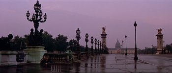 Movie still from “Irma la Douce” (1963), directed by Billy Wilder – A view of a bridge with a statue in the middle of it; Extreme Wide shot, Low angle
