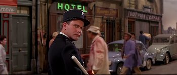 Movie still from “Irma la Douce” (1963), directed by Billy Wilder – A man in a uniform holding a stick in his hand; Medium shot, Low angle