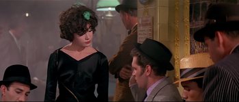 Movie still from “Irma la Douce” (1963), directed by Billy Wilder – A man and a woman are talking to each other; Medium shot, Over the shoulder angle