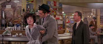 Movie still from “Irma la Douce” (1963), directed by Billy Wilder – A man and a woman in a store; Medium shot, Over the shoulder angle