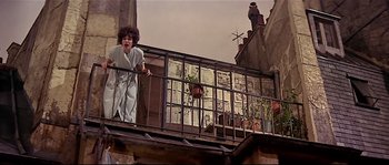 Movie still from “Irma la Douce” (1963), directed by Billy Wilder – A woman standing on a balcony looking out at the sky; Wide shot, Low angle
