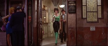 Movie still from “Irma la Douce” (1963), directed by Billy Wilder – A man and a woman walking through a hotel lobby; Wide shot, Low angle