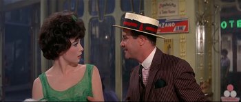 Movie still from “Irma la Douce” (1963), directed by Billy Wilder – A man and a woman talking to each other; Medium shot, Over the shoulder angle