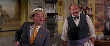 Movie still from “Irma la Douce” (1963), directed by Billy Wilder – A man in a suit and a man in a tie; Medium shot, Over the shoulder angle