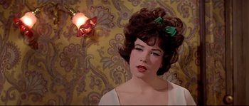 Movie still from “Irma la Douce” (1963), directed by Billy Wilder – A woman with a green bow in her hair; Close Up shot, Low angle