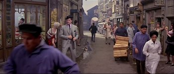 Movie still from “Irma la Douce” (1963), directed by Billy Wilder – A group of people walking down a street; Wide shot, High angle