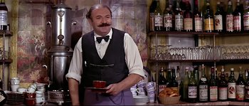 Movie still from “Irma la Douce” (1963), directed by Billy Wilder – A man holding a tray in a restaurant; Medium shot, Low angle