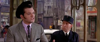 Movie still from “Irma la Douce” (1963), directed by Billy Wilder – A man and a man in a suit and tie; Medium shot, Over the shoulder angle