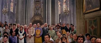 Movie still from “Irma la Douce” (1963), directed by Billy Wilder – A large group of people standing in a church; Wide shot, High angle