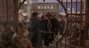 Movie still from “Iron Monkey” (1993), directed by Woo-Ping Yuen – A group of people walking down a street; Wide shot, High angle