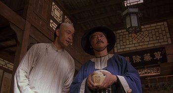 Movie still from “Iron Monkey” (1993), directed by Woo-Ping Yuen – Two men standing next to each other in a room; Medium shot, Low angle