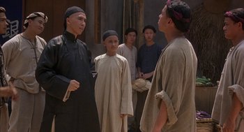 Movie still from “Iron Monkey” (1993), directed by Woo-Ping Yuen – A group of young men standing next to each other; Medium shot, Over the shoulder angle