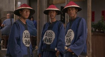 Movie still from “Iron Monkey” (1993), directed by Woo-Ping Yuen – A group of men wearing hats standing next to each other; Medium shot, High angle