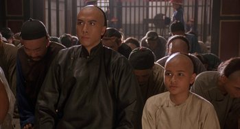 Movie still from “Iron Monkey” (1993), directed by Woo-Ping Yuen – A group of people sitting next to each other in a room; Close Up shot, Over the shoulder angle