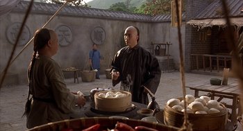 Movie still from “Iron Monkey” (1993), directed by Woo-Ping Yuen – A man standing in front of a pot of food; Medium shot, Over the shoulder angle