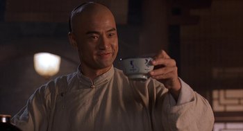 Movie still from “Iron Monkey” (1993), directed by Woo-Ping Yuen – A man holding a tea cup in his hand; Close Up shot, Low angle