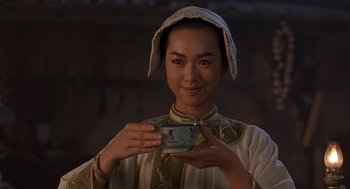 Movie still from “Iron Monkey” (1993), directed by Woo-Ping Yuen – A woman holding a cup in her hands; Close Up shot, Low angle