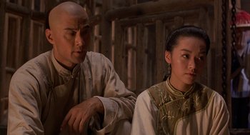 Movie still from “Iron Monkey” (1993), directed by Woo-Ping Yuen – A man and a woman sitting next to each other; Close Up shot, Over the shoulder angle