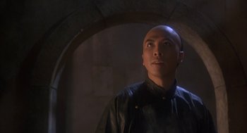 Movie still from “Iron Monkey” (1993), directed by Woo-Ping Yuen – A man standing in front of an archway looking up; Close Up shot, Low angle