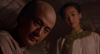 Movie still from “Iron Monkey” (1993), directed by Woo-Ping Yuen – A man and a woman standing next to each other; Close Up shot, Low angle