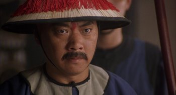 Movie still from “Iron Monkey” (1993), directed by Woo-Ping Yuen – A person wearing a hat; Close Up shot, High angle