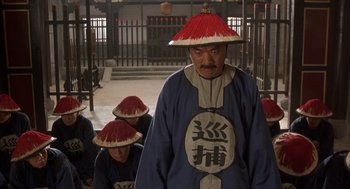 Movie still from “Iron Monkey” (1993), directed by Woo-Ping Yuen – A group of people wearing hats in a room; Medium shot, High angle