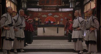 Movie still from “Iron Monkey” (1993), directed by Woo-Ping Yuen – A group of people standing in front of an audience; Wide shot, Low angle