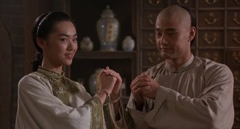 Movie still from “Iron Monkey” (1993), directed by Woo-Ping Yuen – A man and a woman holding hands in a room; Close Up shot, Over the shoulder angle